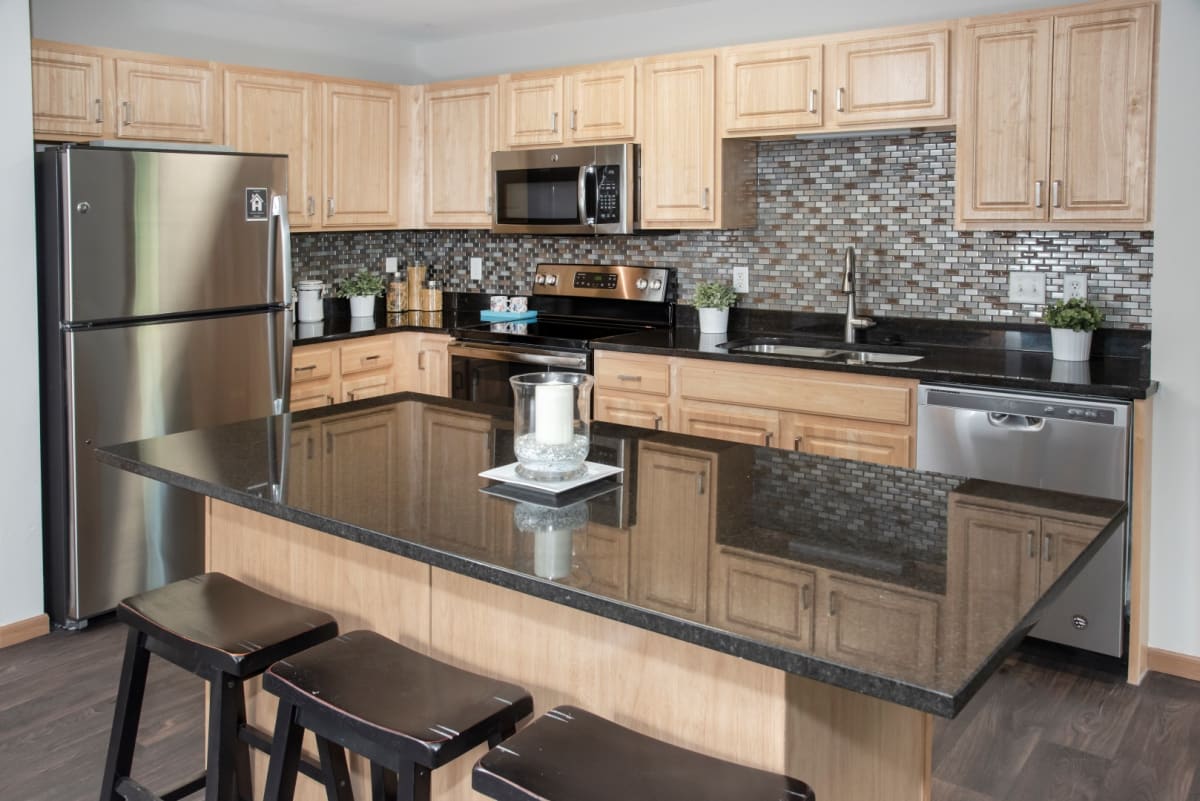 Apartment kitchen with granite island and seating