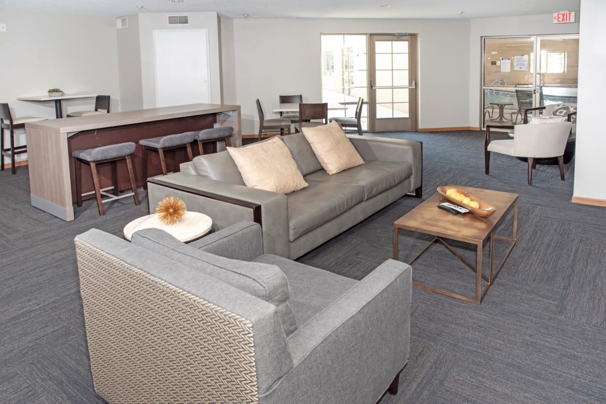 Community room with sofas and an adjoining kitchen