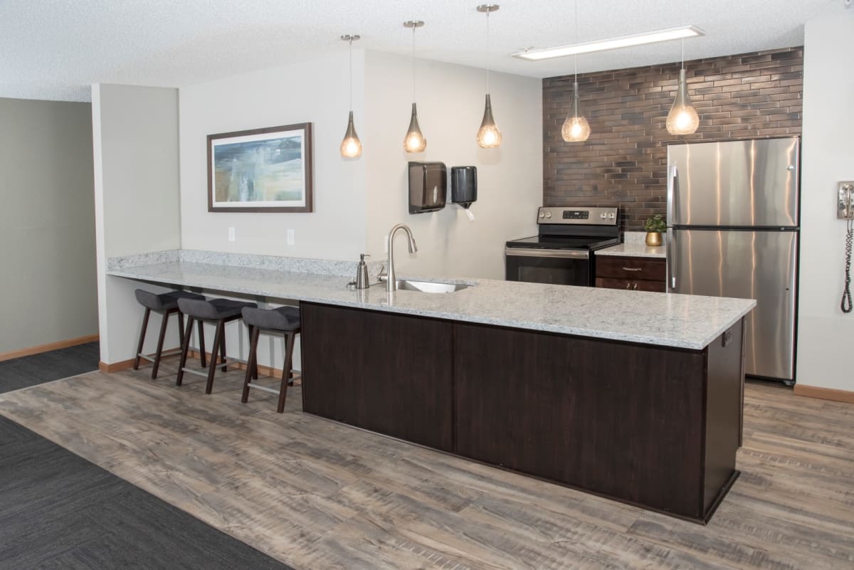 Community room kitchen with a large island and bar seating