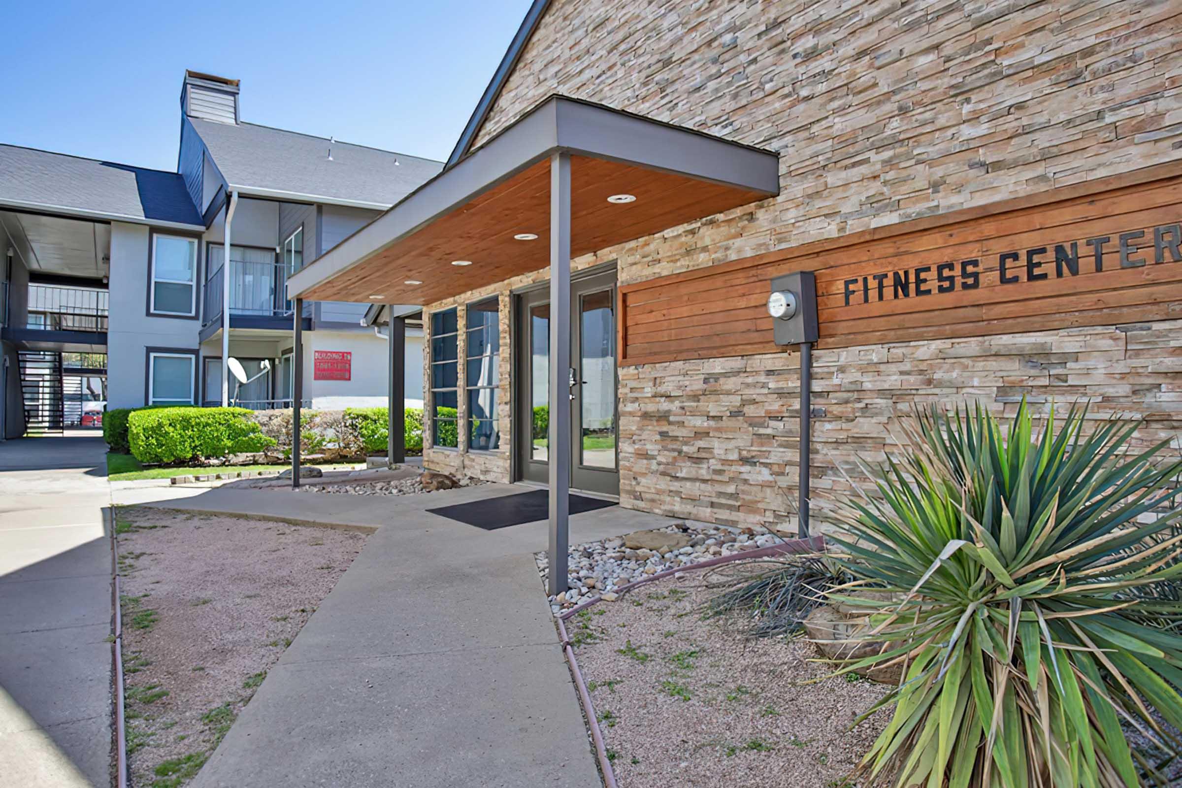 District at Midtown fitness center exterior and landscaped walkway.