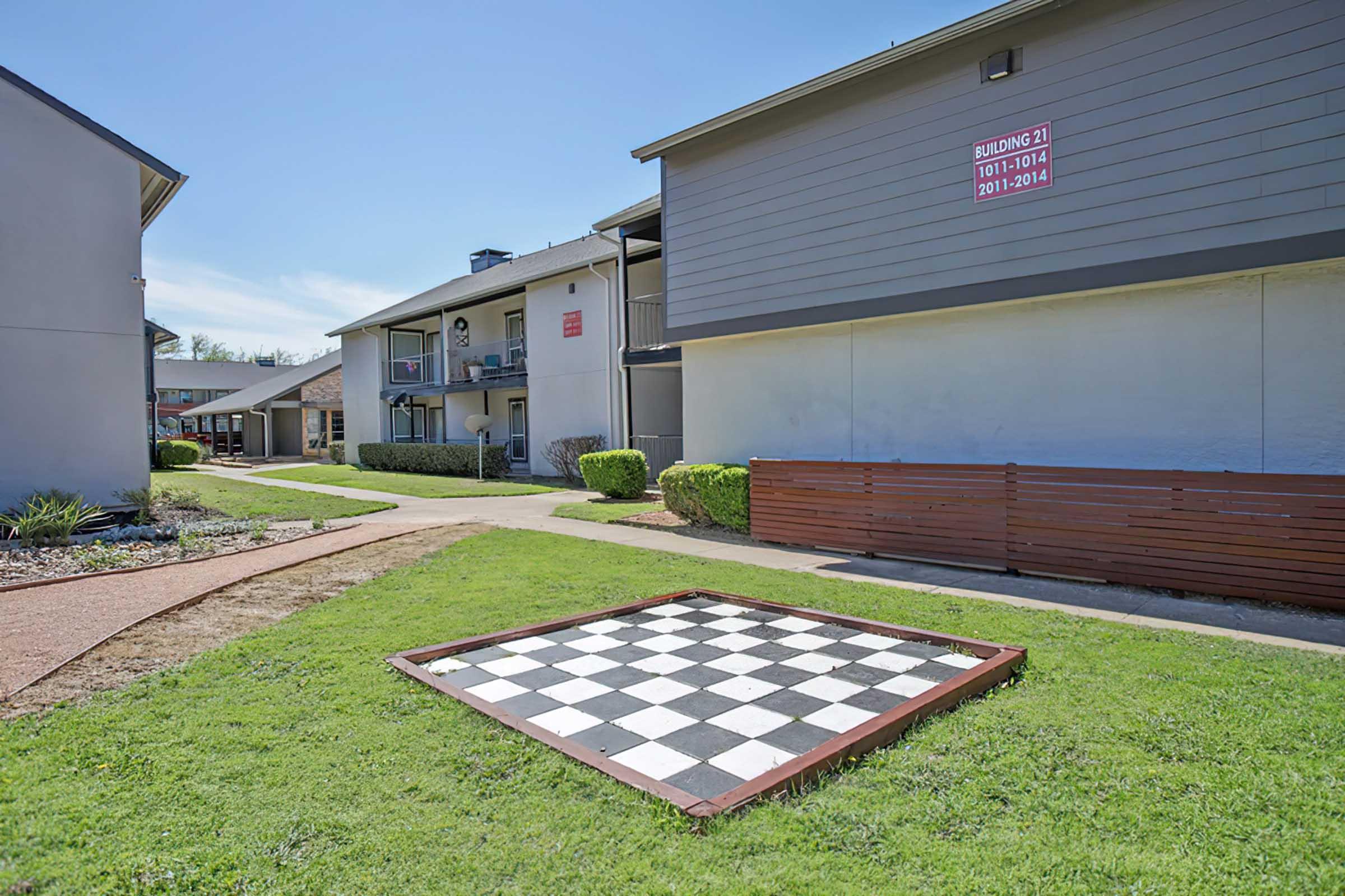 Outdoor chessboard beside District at Midtown apartment buildings.