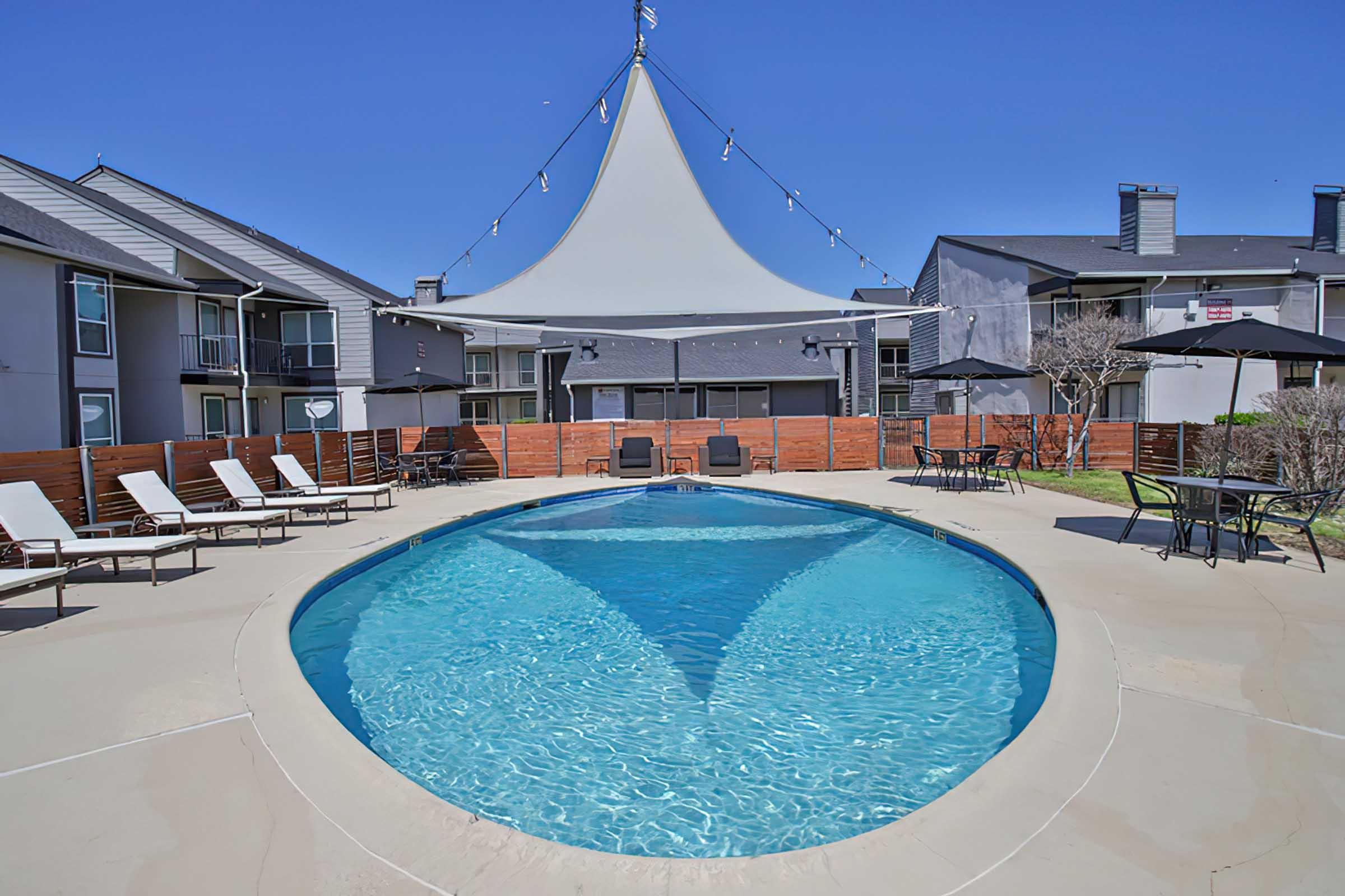 District at Midtown swimming pool with shade canopy and lounge chairs.