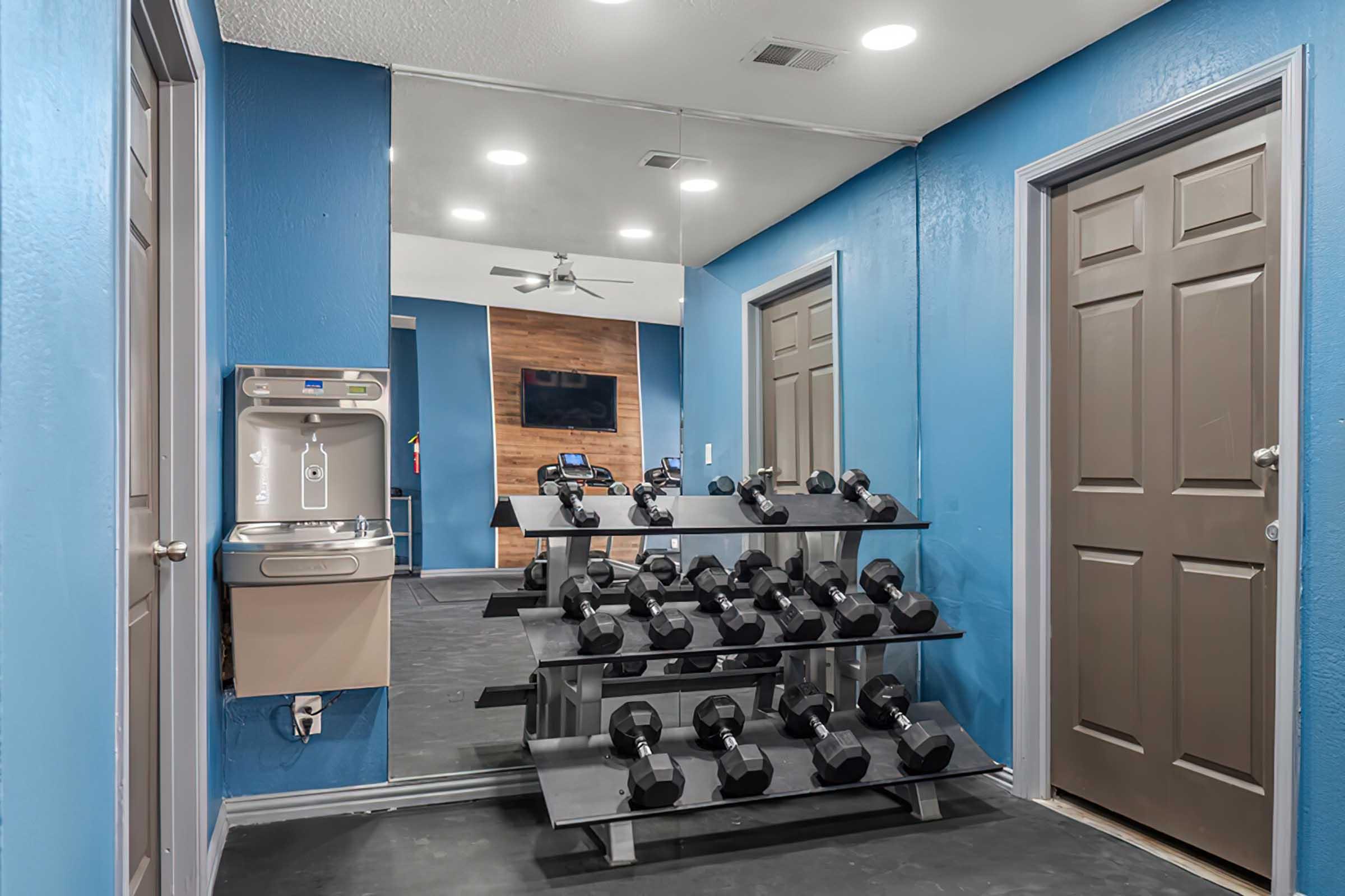 Free weights and mirrors in the District at Midtown fitness center.