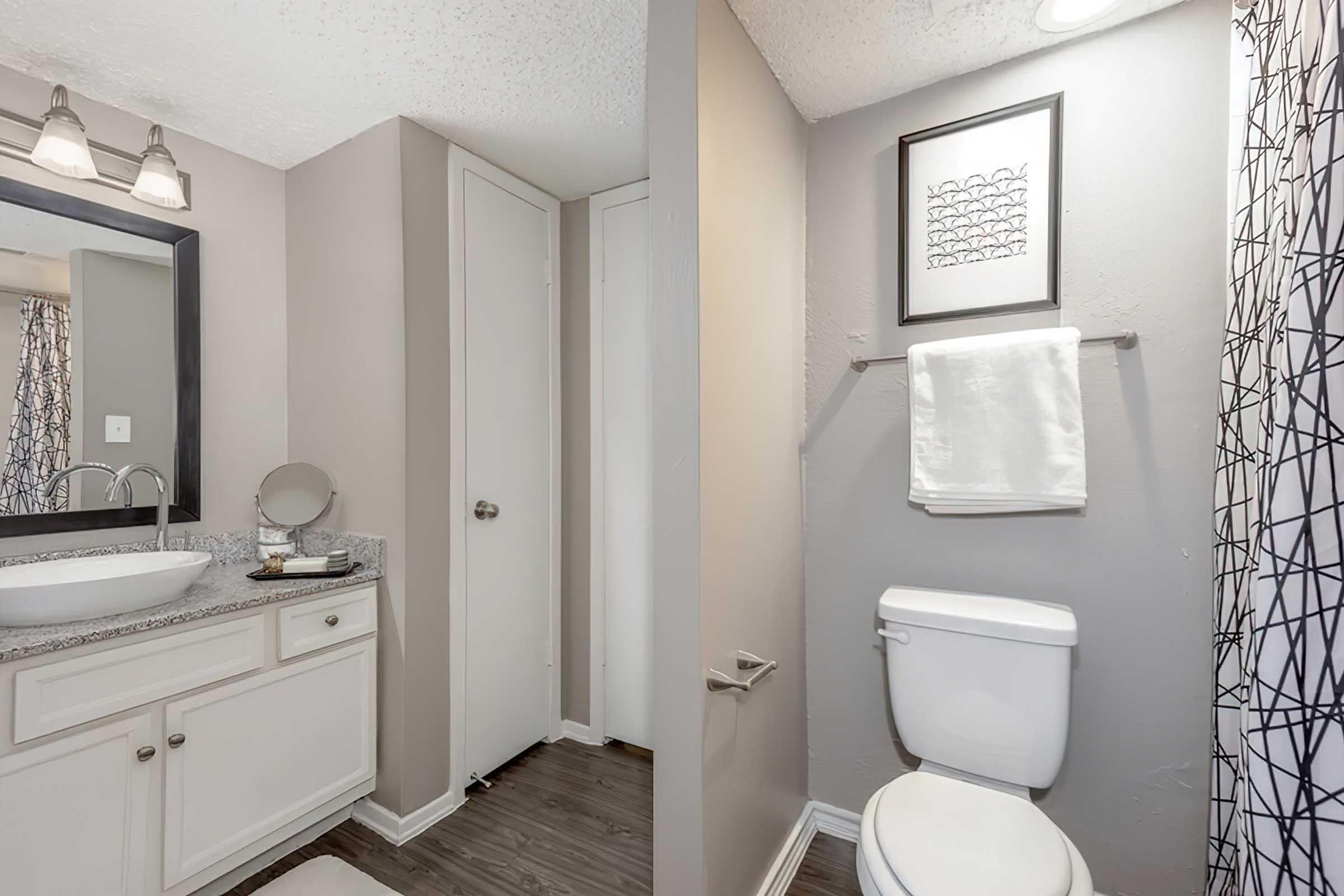 District at Midtown model bathroom with vanity and framed mirror.