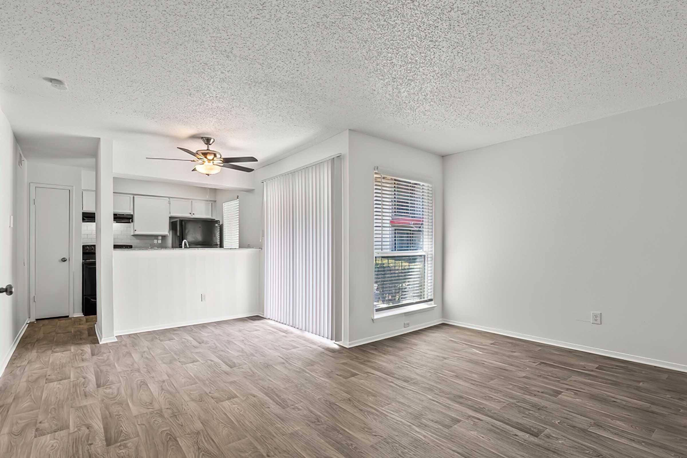 Unfurnished District at Midtown living area with patio access.