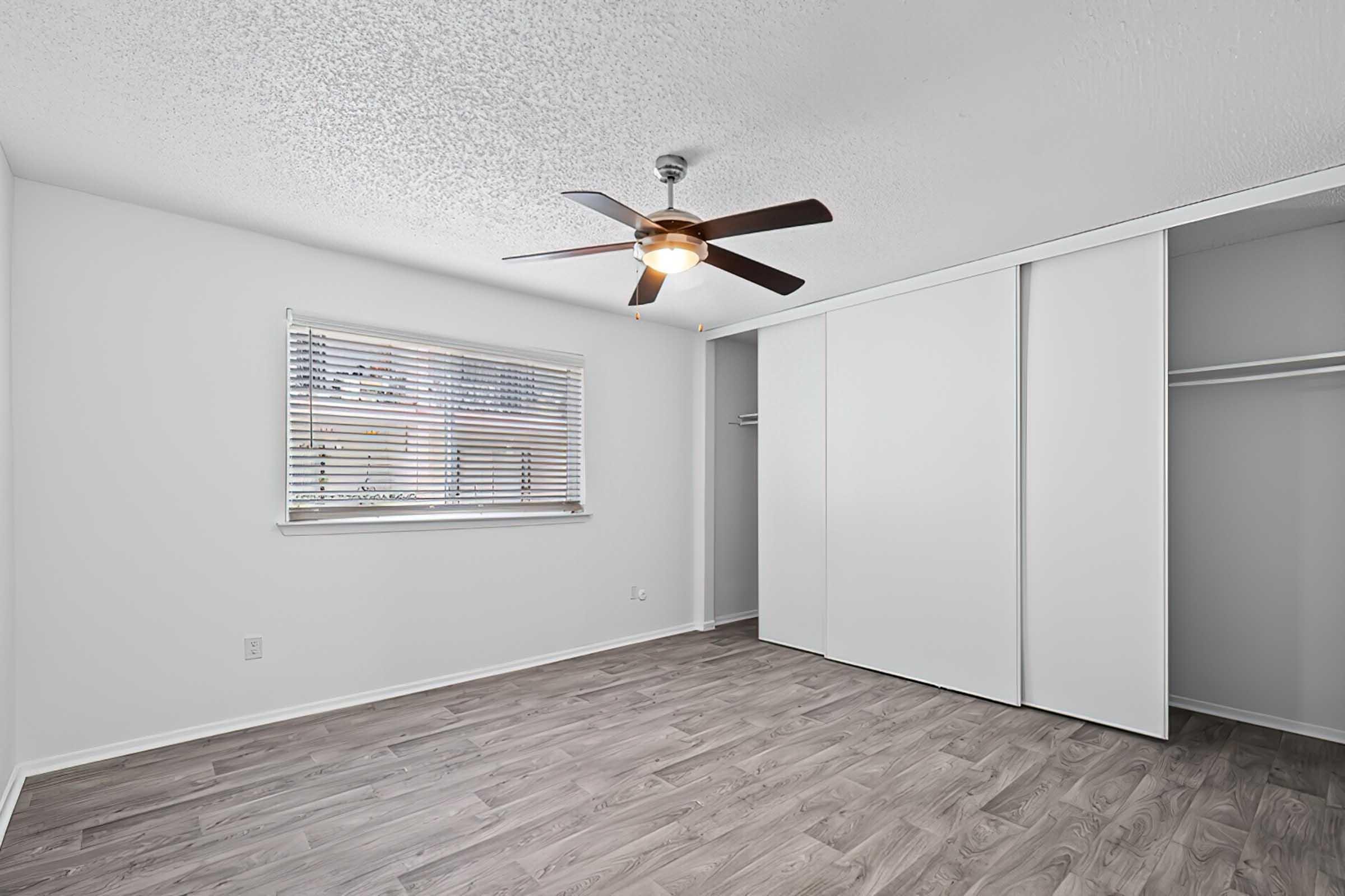 Unfurnished District at Midtown bedroom with ceiling fan and closet.