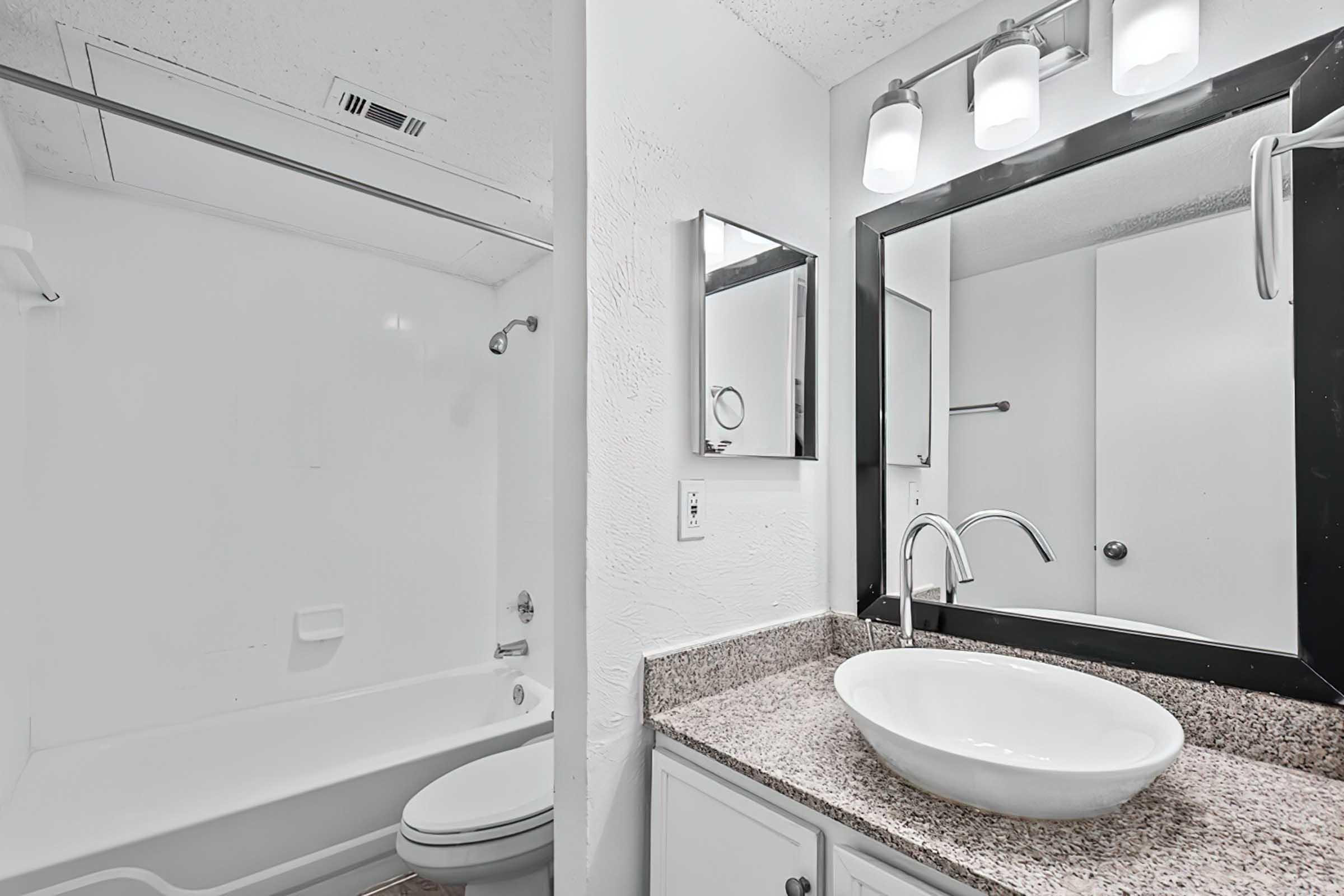 District at Midtown bathroom with vessel sink and bathtub.