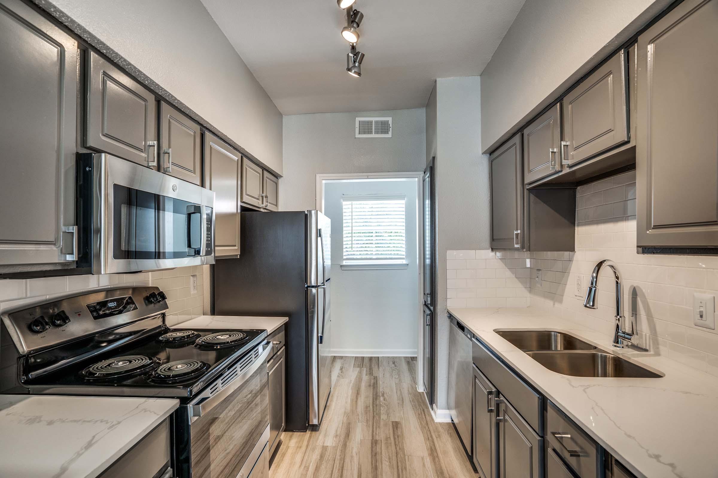 Winston apartment kitchen with dark cabinetry