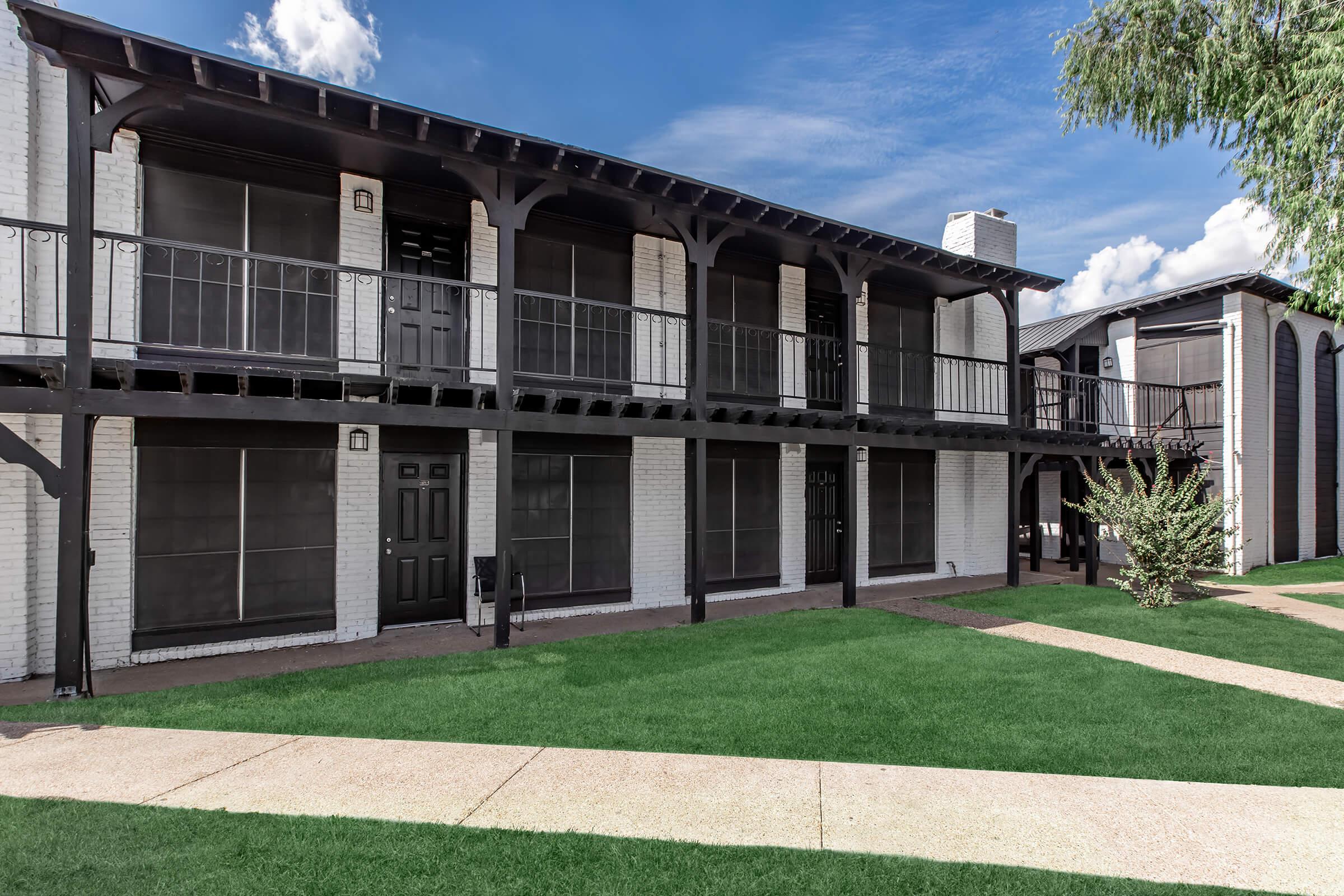 Maravilla apartment buildings facing landscaped lawns and paths.