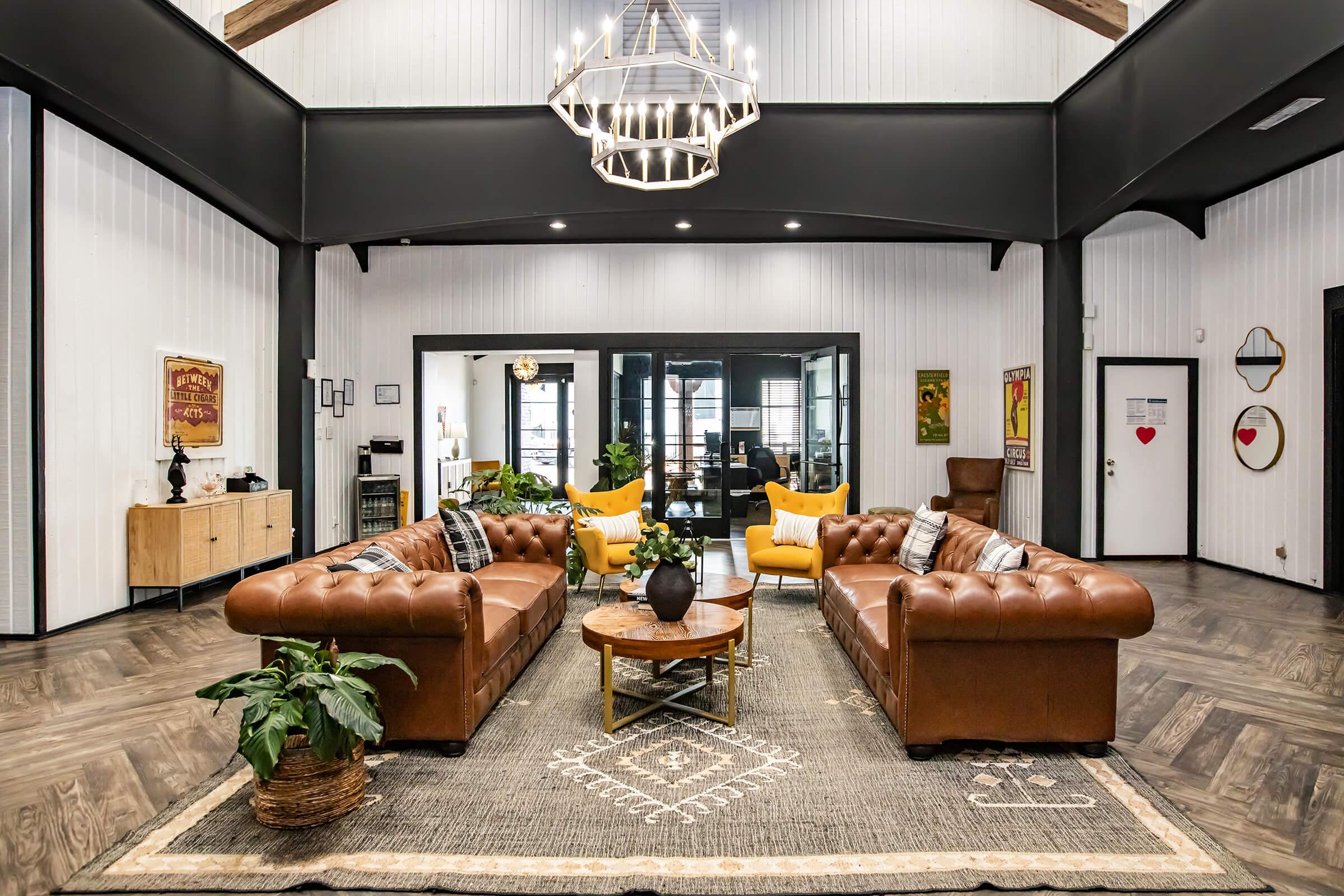 Maravilla clubhouse lounge with leather sofas and tall windows.