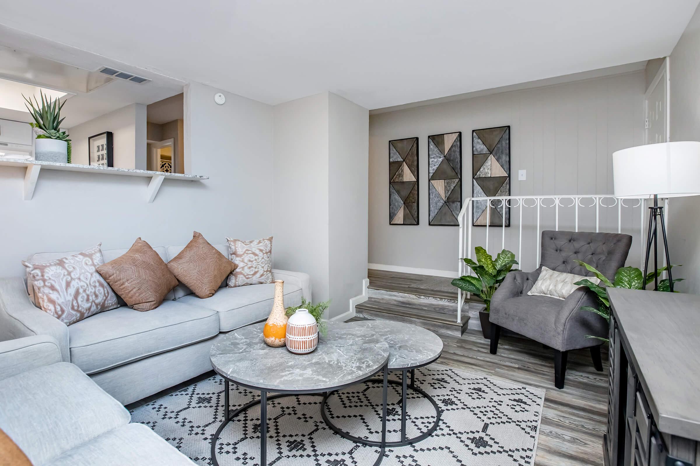 Furnished Maravilla model living room with sofa and patterned rug.