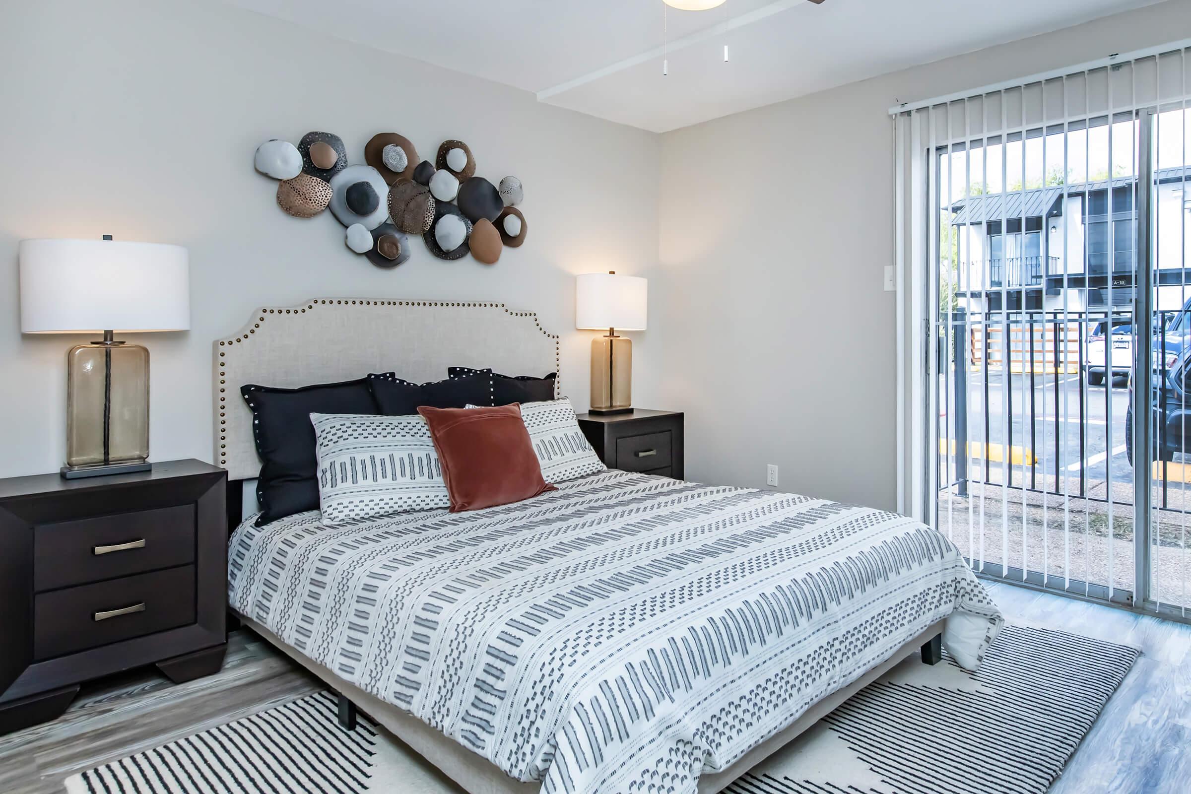 Furnished Maravilla model bedroom with sliding glass door.