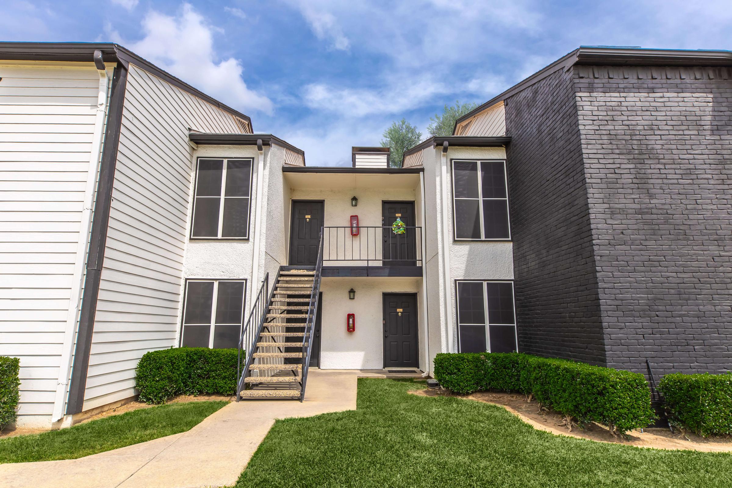 Apartment building walkway and landscaped lawn