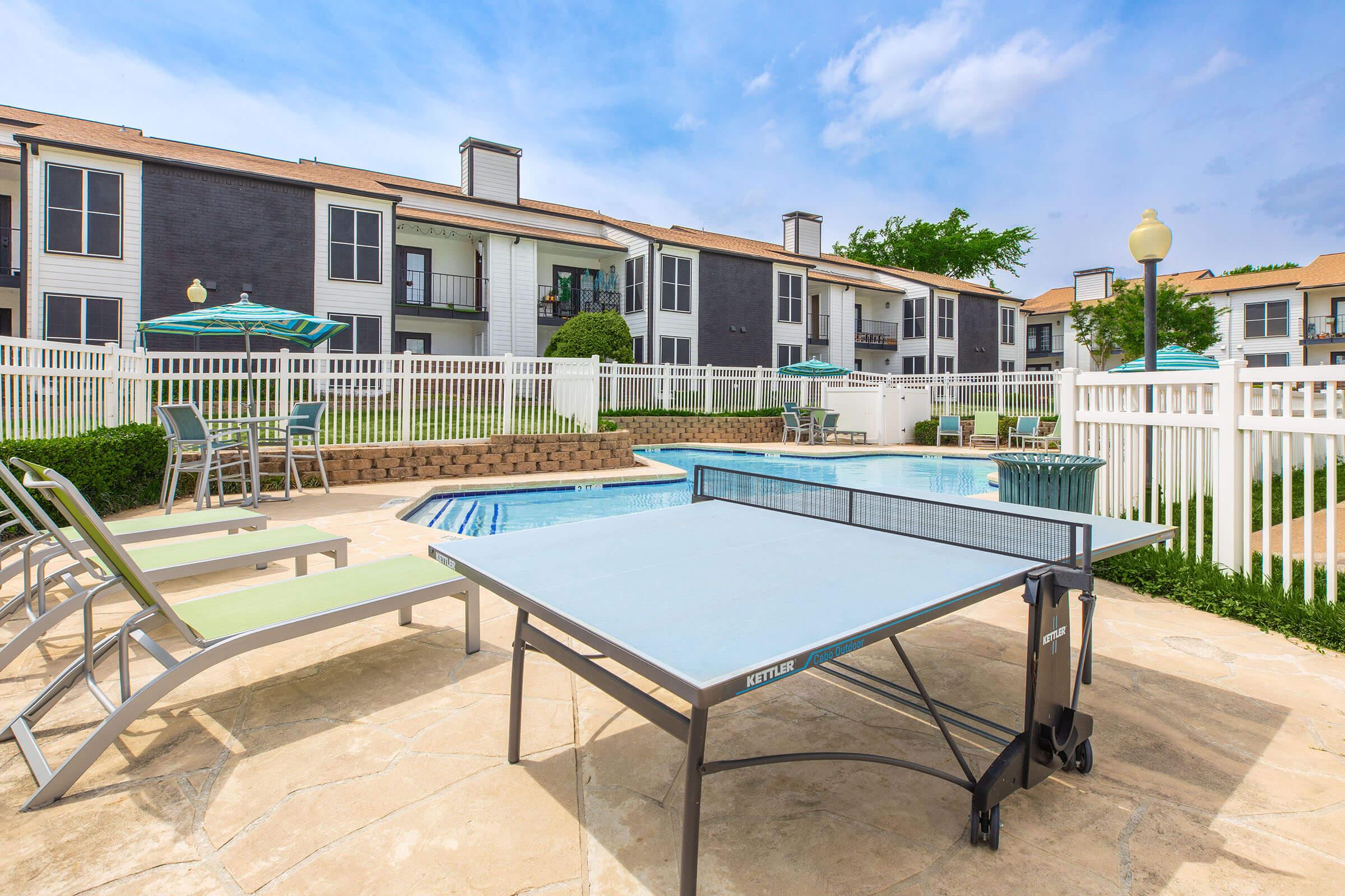 Outdoor table tennis beside the swimming pool