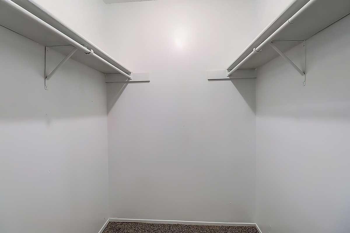Walk-in closet with hanging rails and shelving