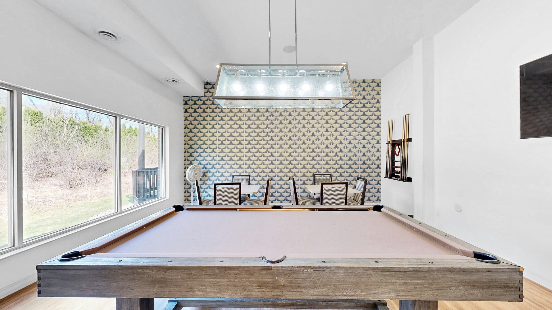 Waterstone Place game room with a billiards table and large windows.