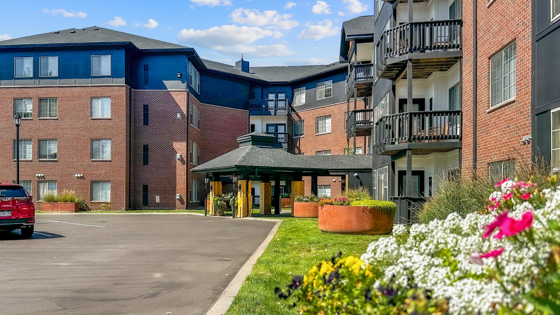Landscaped main entrance and apartment balconies at Waterstone Place.